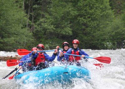 A group of six paddling down the Klickitat river and getting splashed.