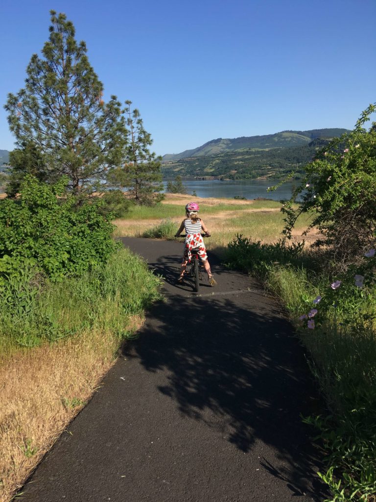 Aurora rides her bike on the lower Catherine Creek trail.